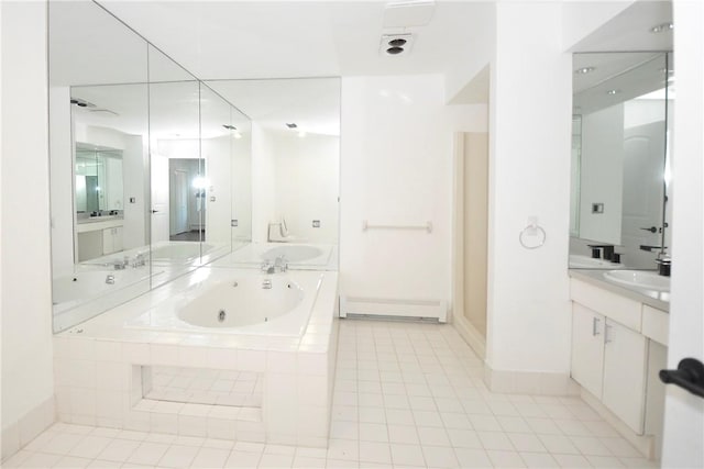 bathroom featuring tile patterned floors, vanity, tiled tub, and a baseboard heating unit