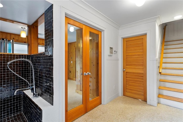 corridor featuring crown molding and carpet floors