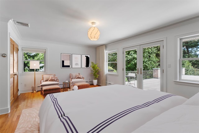 bedroom with access to outside, french doors, light wood-type flooring, a baseboard heating unit, and visible vents