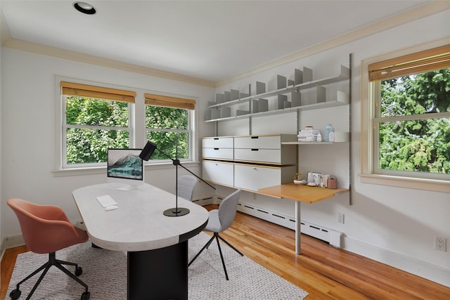 office space featuring baseboards, a baseboard radiator, and wood finished floors