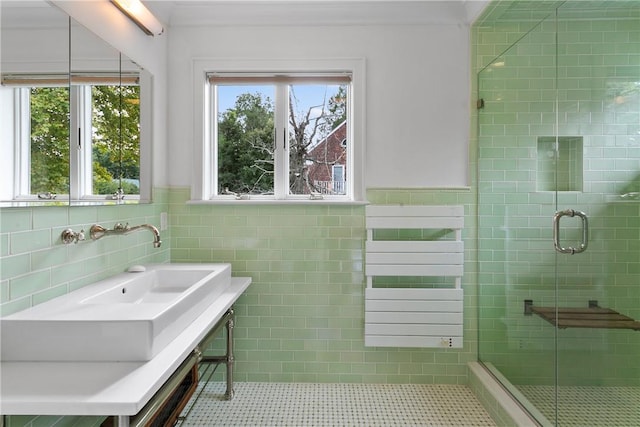 full bathroom with a wainscoted wall, a stall shower, and tile walls