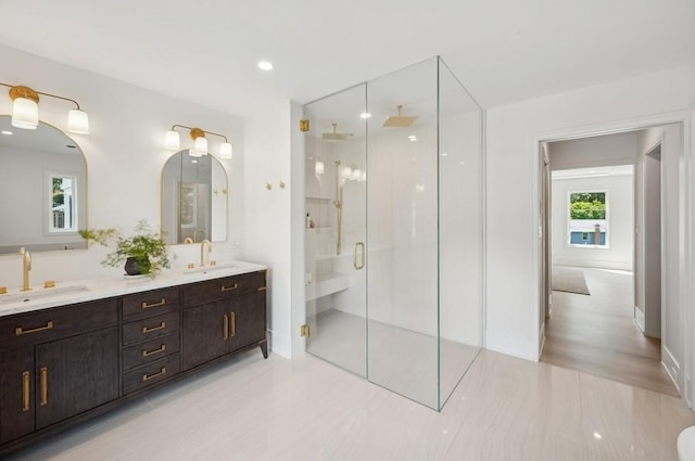 bathroom with walk in shower and vanity