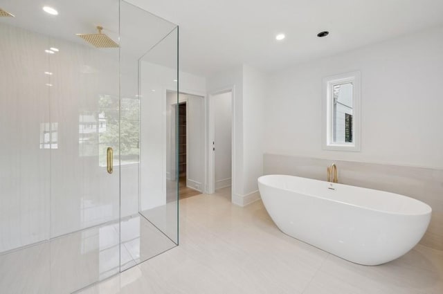 bathroom featuring independent shower and bath