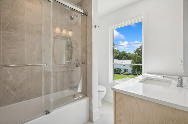 full bathroom featuring toilet, vanity, and enclosed tub / shower combo