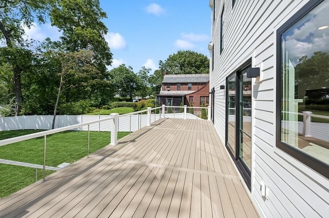 wooden deck featuring a lawn