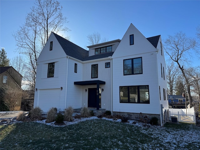 view of front of property with a garage and a front lawn