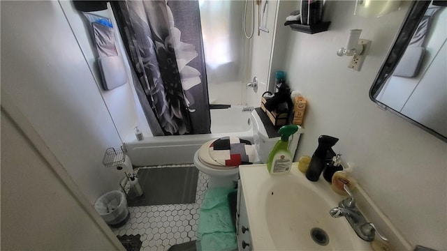 bathroom featuring shower / bath combination with curtain, toilet, and a sink