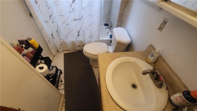 full bathroom with shower / tub combo, toilet, and a sink