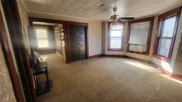 spare room with cooling unit, carpet, plenty of natural light, and baseboards