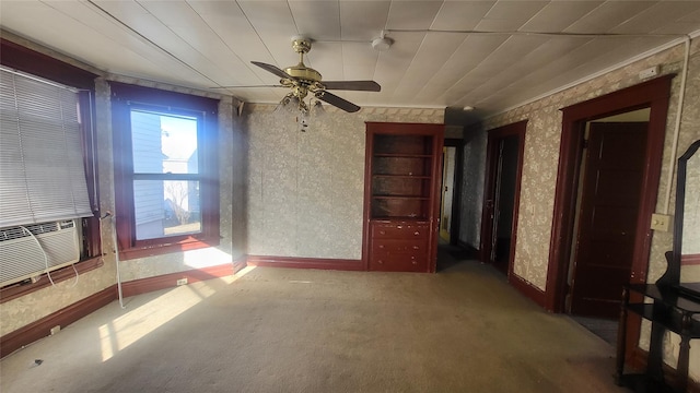 empty room with cooling unit, carpet, baseboards, wallpapered walls, and ceiling fan