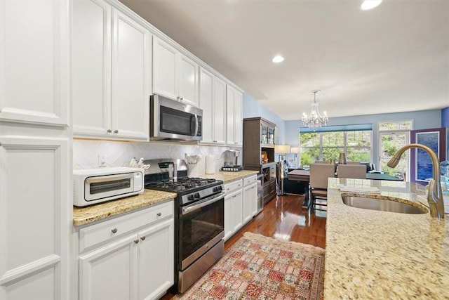 kitchen featuring white cabinets, stainless steel appliances, and sink