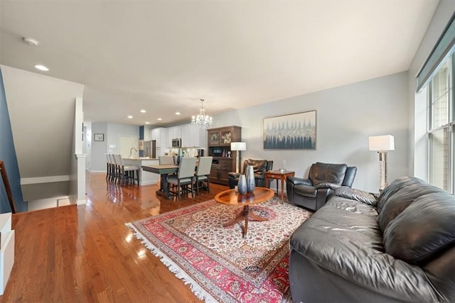 living room featuring hardwood / wood-style floors and a notable chandelier