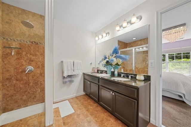 bathroom featuring a tile shower and vanity