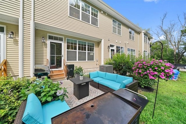 view of patio with an outdoor living space with a fire pit and central AC unit