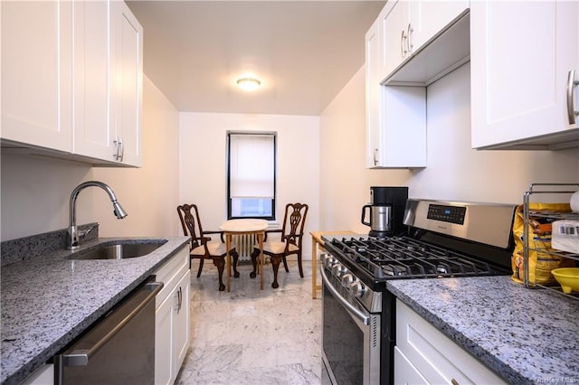 kitchen with white cabinets, appliances with stainless steel finishes, and sink