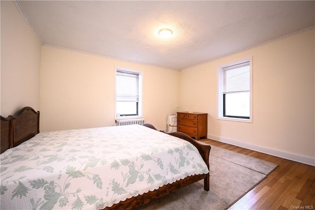 bedroom featuring dark hardwood / wood-style floors and radiator heating unit