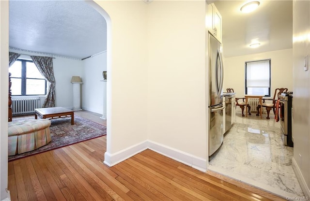 hall featuring radiator and light wood-type flooring