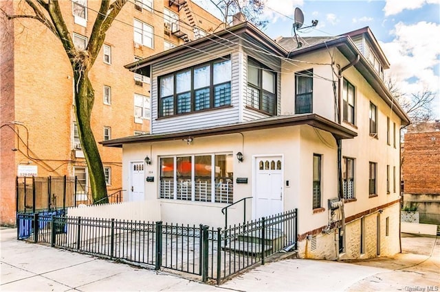 204 W 260th St, Bronx, NY 10471 - view of front of house featuring a fenced front yard and stucco siding