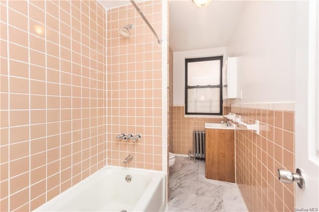 204 W 260th St, Bronx, NY 10471 - bathroom featuring radiator, tile walls, vanity, washtub / shower combination, and marble look tile flooring