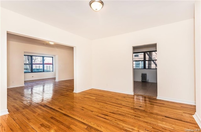 204 W 260th St, Bronx, NY 10471 - empty room with radiator heating unit and wood-type flooring