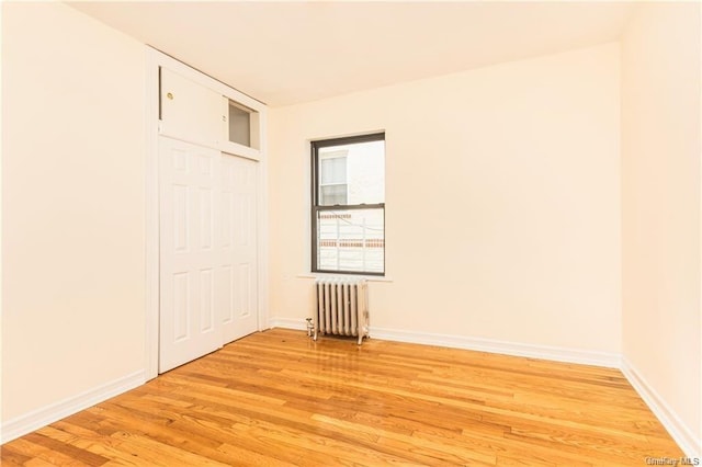 204 W 260th St, Bronx, NY 10471 - unfurnished bedroom featuring radiator, light wood-style floors, and a closet