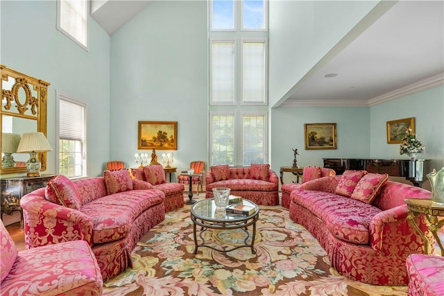 living room with a high ceiling and ornamental molding