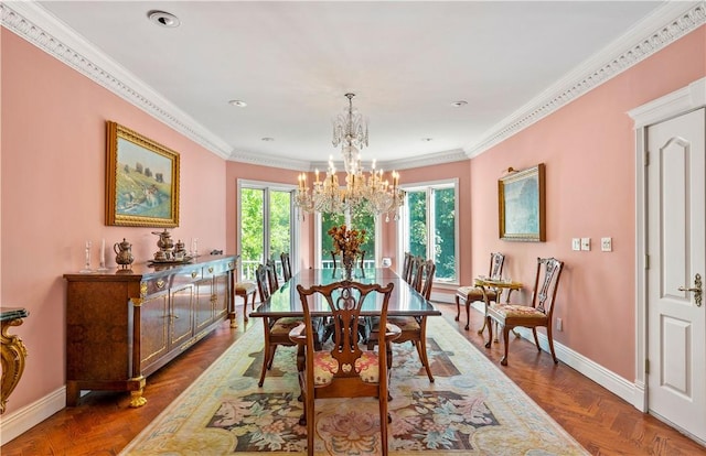 dining area with dark parquet flooring, crown molding, and an inviting chandelier