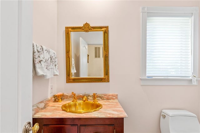 bathroom featuring vanity and toilet