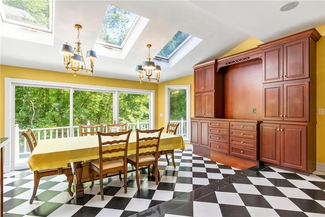 dining area featuring vaulted ceiling with skylight and a notable chandelier