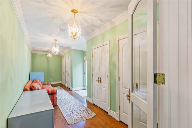 interior space with crown molding, hardwood / wood-style floors, and a chandelier