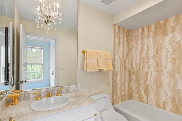 full bathroom featuring an inviting chandelier, vanity, shower / bathtub combination, and toilet