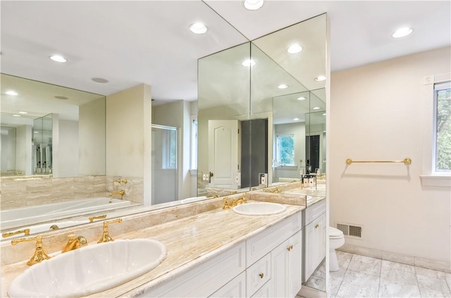 bathroom featuring vanity, toilet, and an enclosed shower