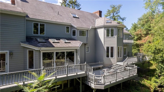 back of property with a wooden deck