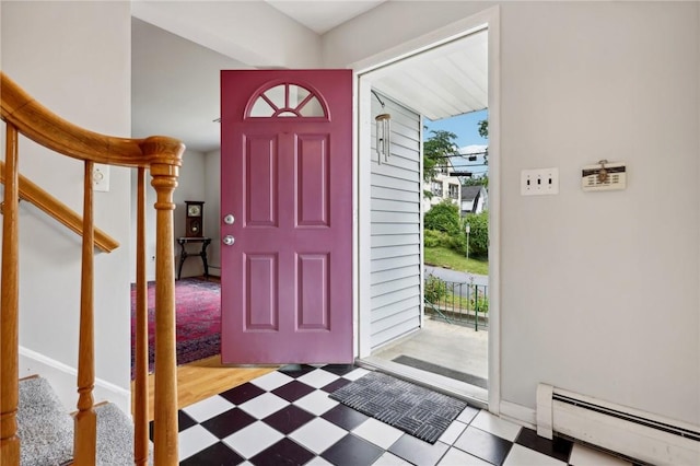 entrance foyer with light hardwood / wood-style flooring and a baseboard heating unit