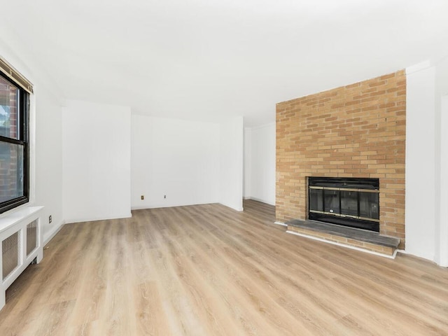 unfurnished living room with light hardwood / wood-style floors and a fireplace