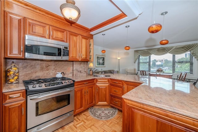 kitchen with pendant lighting, crown molding, sink, appliances with stainless steel finishes, and kitchen peninsula