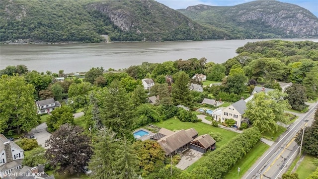 drone / aerial view featuring a water and mountain view