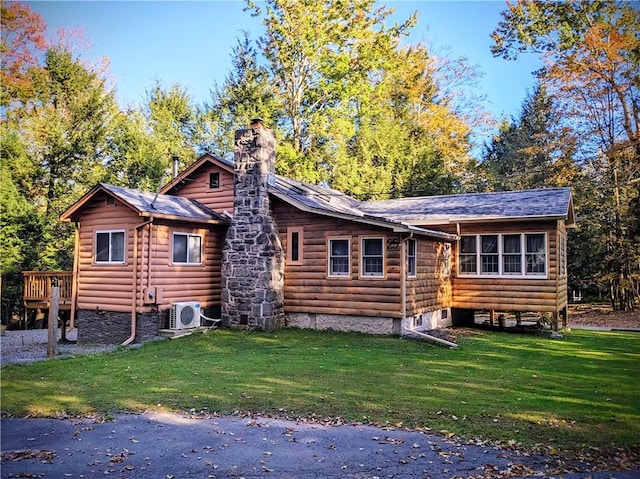 back of house featuring ac unit, a deck, and a yard