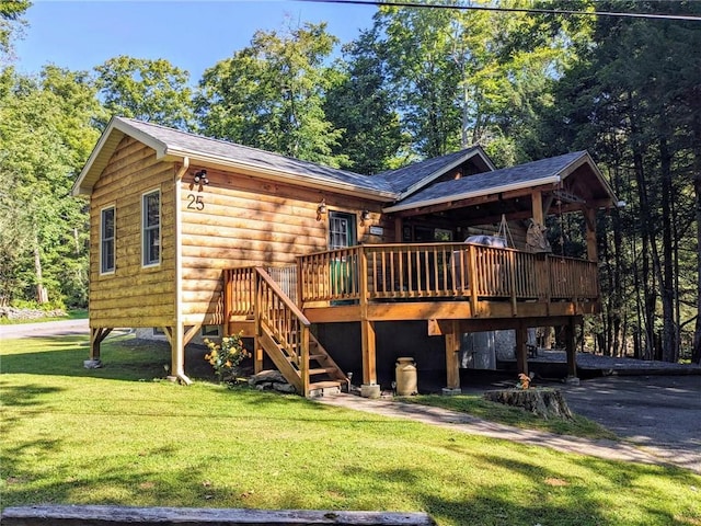 rear view of property featuring a yard and a deck