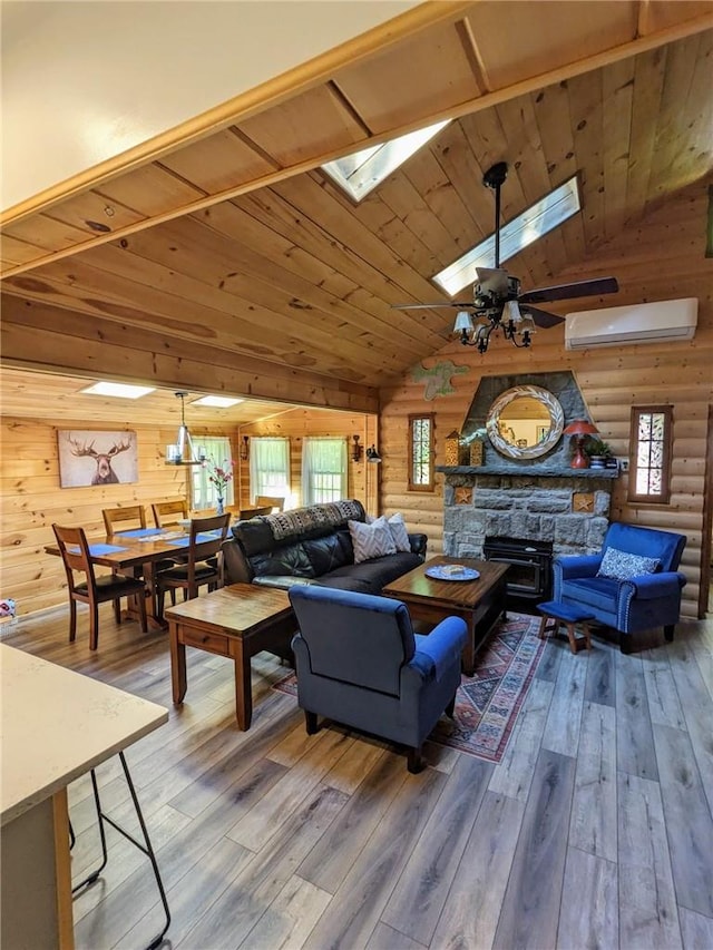 living room featuring a wall mounted AC, hardwood / wood-style floors, wood ceiling, and vaulted ceiling with skylight