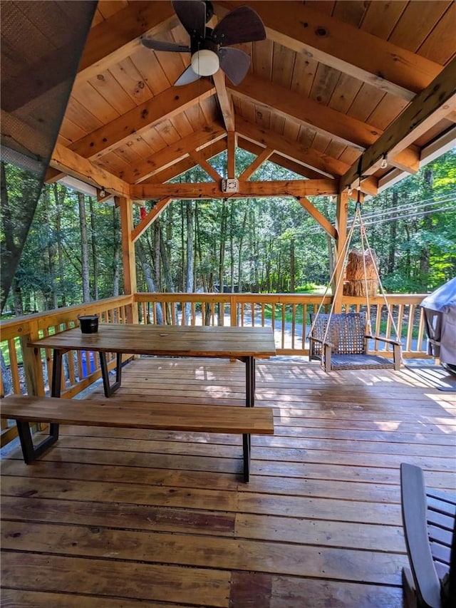 wooden terrace with a gazebo and ceiling fan