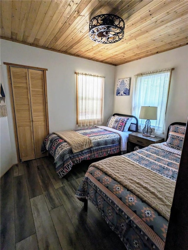 bedroom with hardwood / wood-style flooring, multiple windows, and wooden ceiling