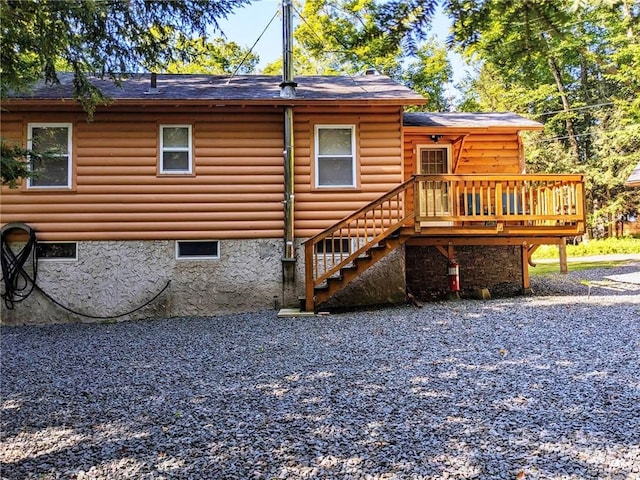 back of property with a wooden deck