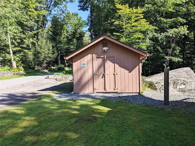 view of outbuilding with a lawn