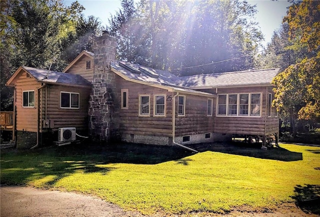 back of house featuring ac unit and a yard