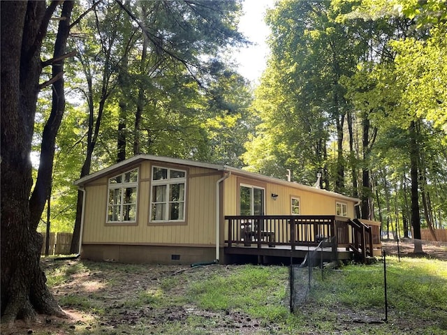 rear view of house featuring a wooden deck