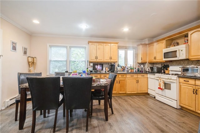 kitchen featuring light hardwood / wood-style floors, white appliances, light brown cabinets, and a wealth of natural light