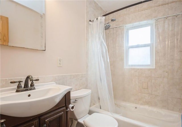 full bathroom featuring vanity, toilet, shower / bathtub combination with curtain, and tile walls