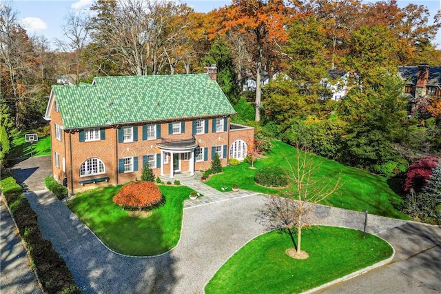 290 Overlook Rd, New Rochelle, NY 10804 - colonial house featuring a chimney, a front yard, and brick siding