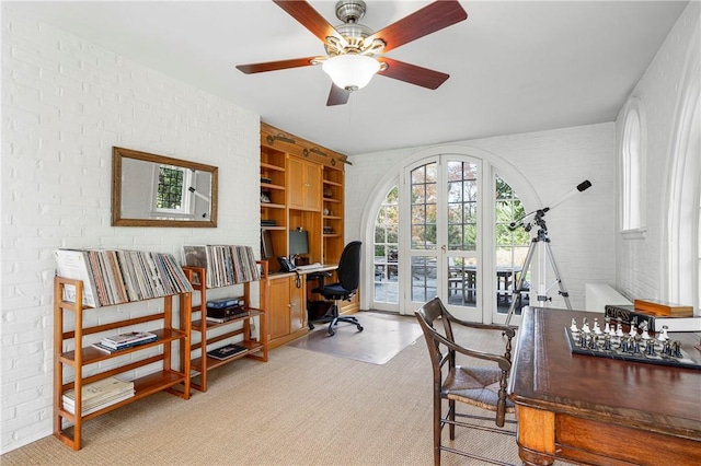 office featuring ceiling fan, brick wall, and french doors